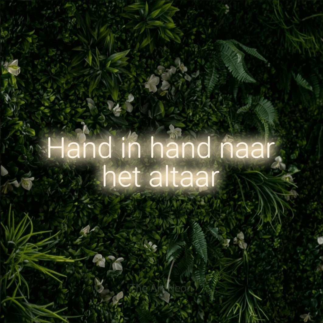 LED neon sign reading “Hand in hand naar het altaar”, arranged in 2 lines.