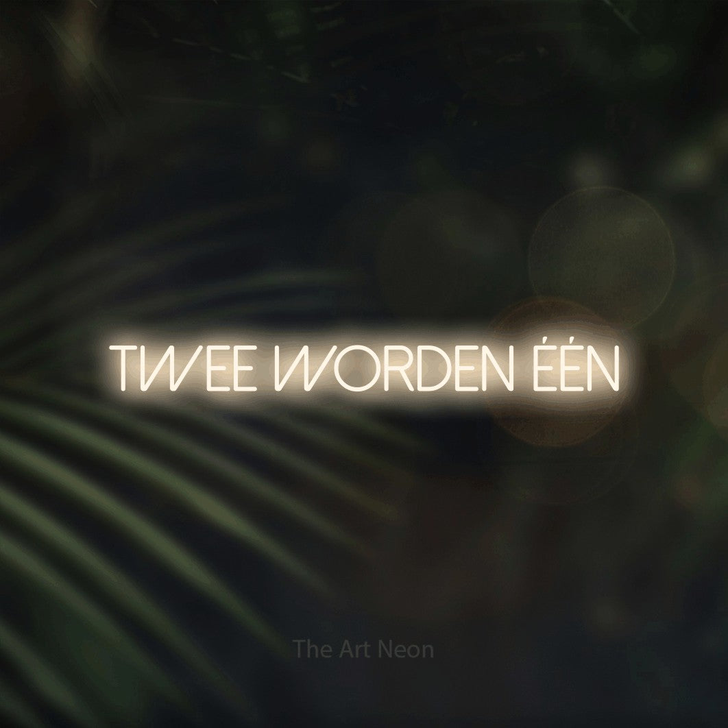 LED neon sign reading “TWEE WORDEN ÉÉN”, arranged in a single line.