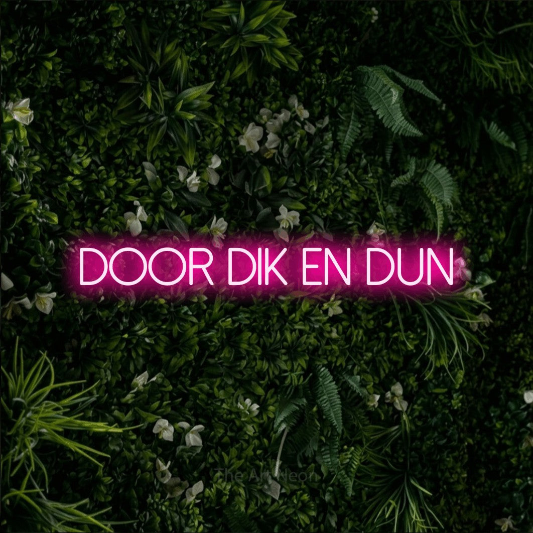 LED neon sign reading “Door Dik En Dun”, arranged in a single line.