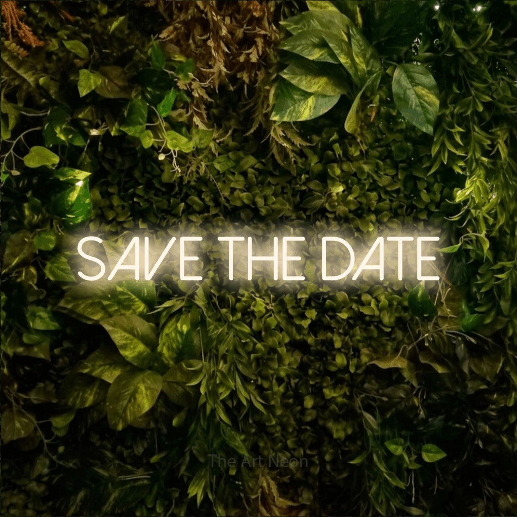 LED neon sign reading “save the date”, arranged in a single line.