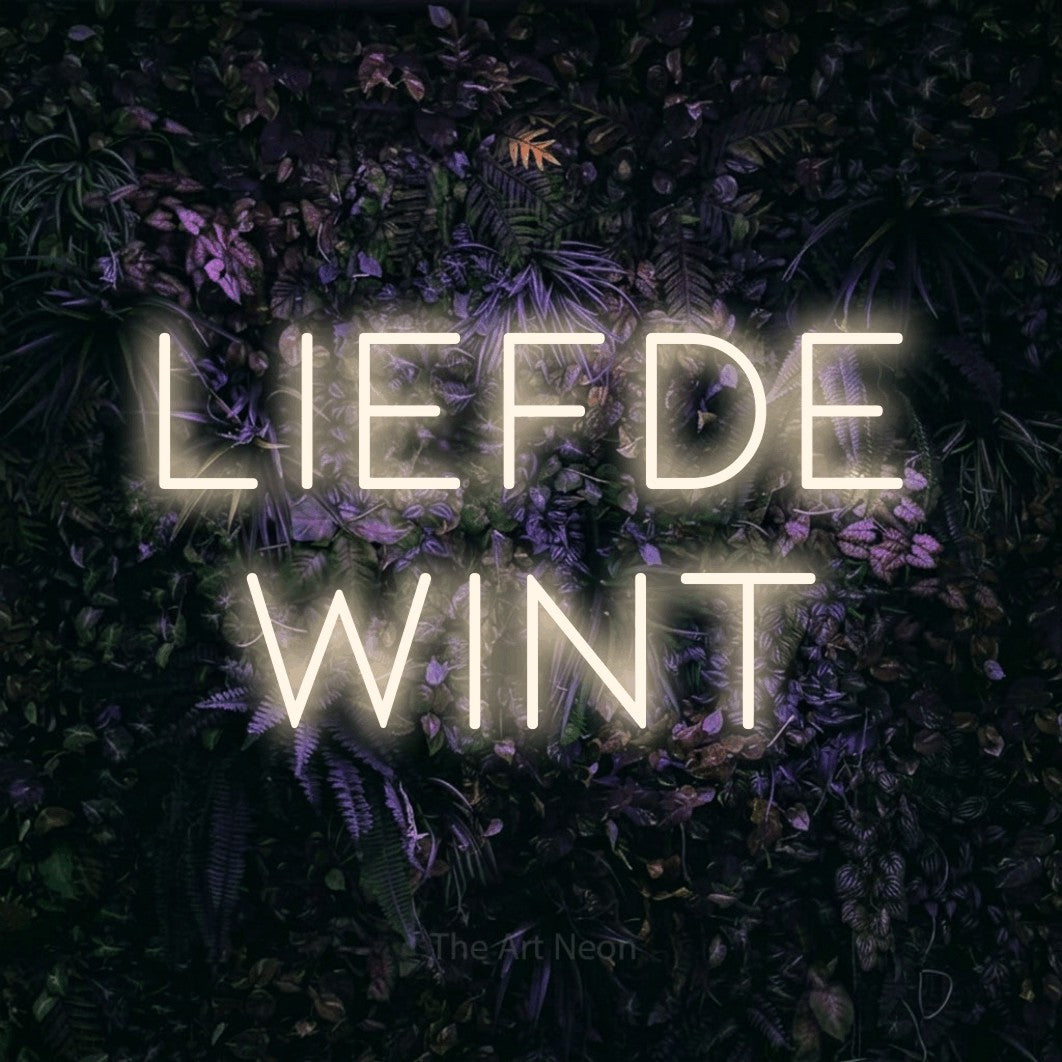 LED neon sign reading “liefde wint”, arranged in 2 lines.