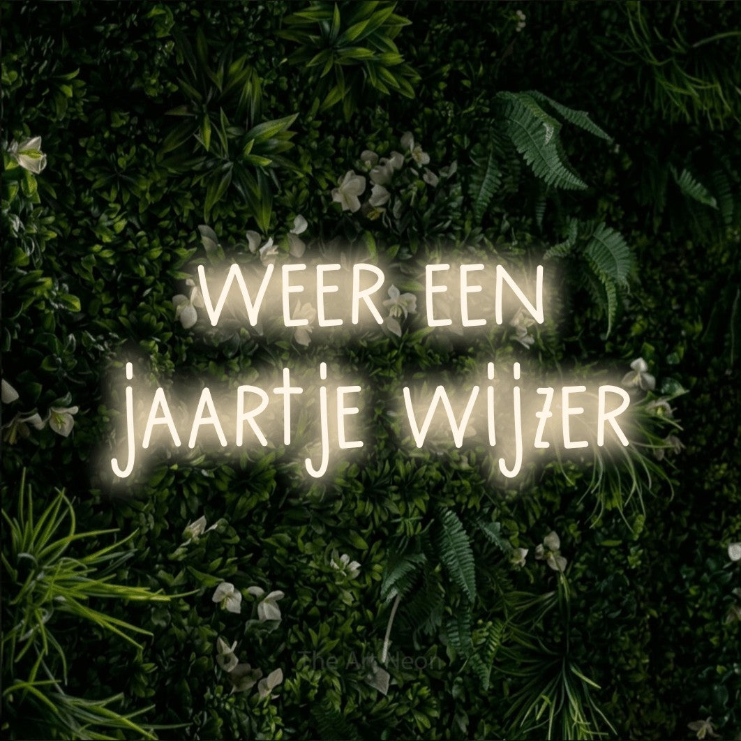 LED neon sign reading “weer een jaartje wijzer”, arranged in 2 lines.