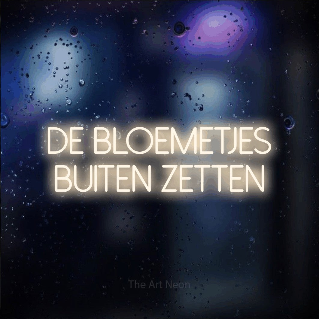 LED neon sign reading “De Bloemetjes Buiten Zetten”, arranged in 2 lines.
