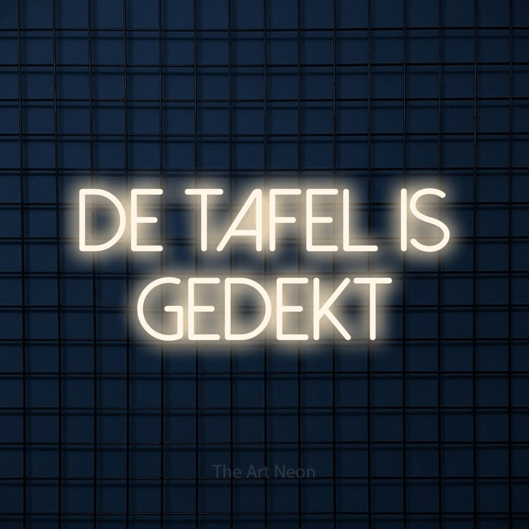 LED neon sign reading “de tafel is gedekt”, arranged in 2 lines.