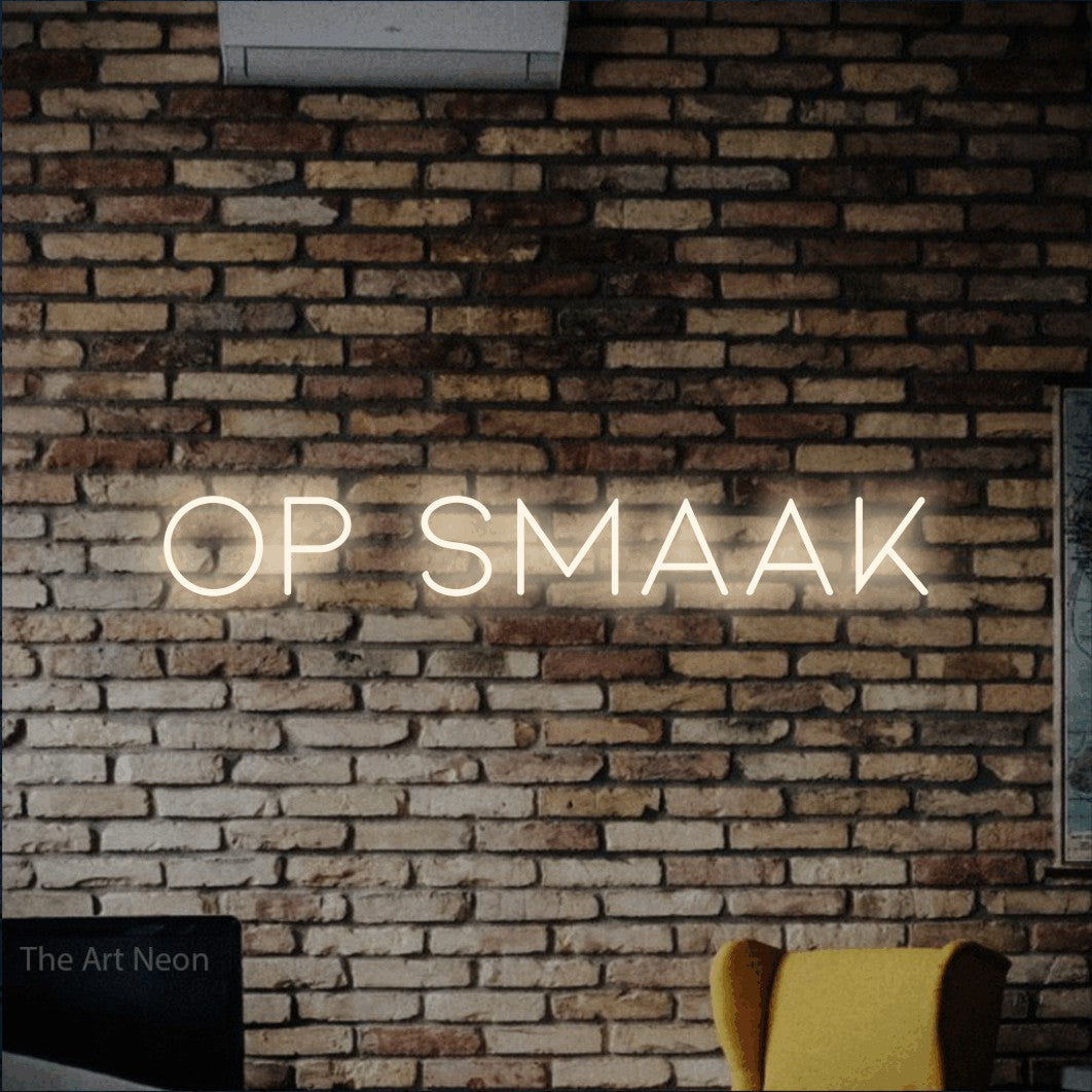 LED neon sign reading “Op smaak”, arranged in a single line.