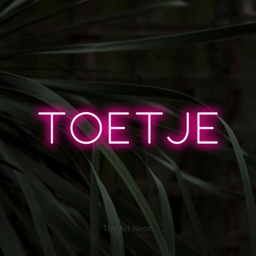 LED neon sign reading “toetje”, arranged in a single line.