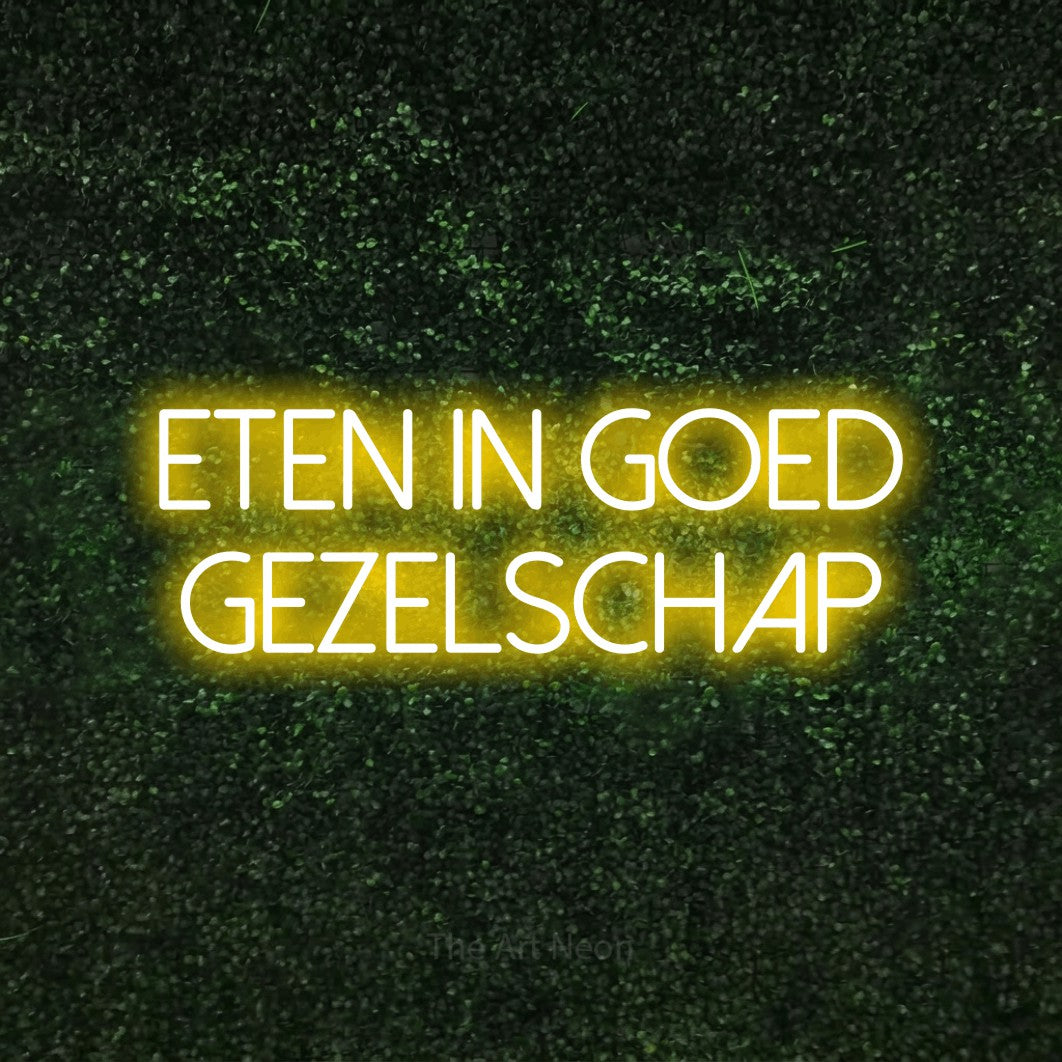 LED neon sign reading “eten in goed gezelschap”, arranged in 2 lines.