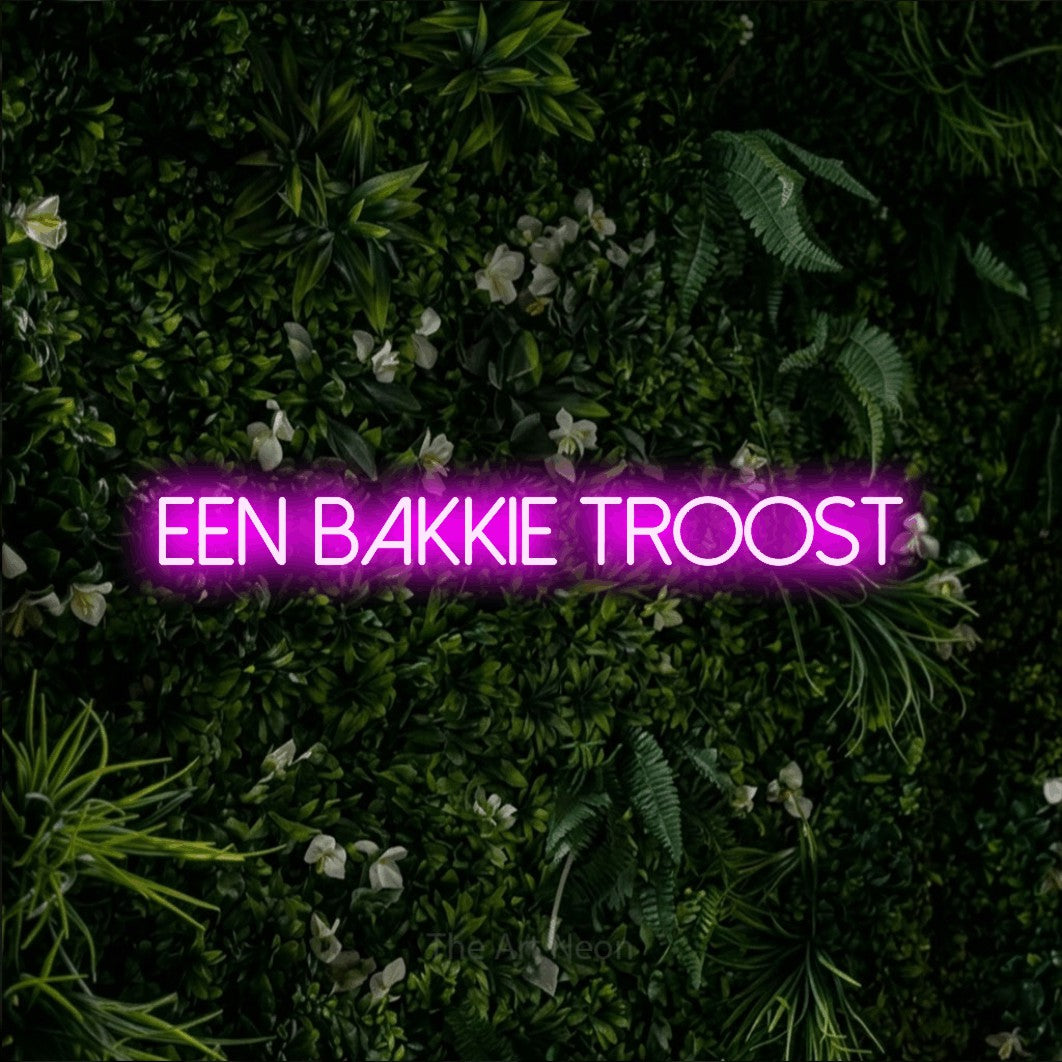 LED neon sign reading “EEN bakkie troost”, arranged in a single line.