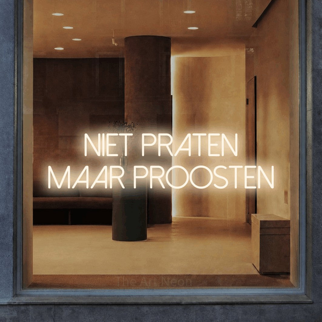 LED neon sign reading “NIET PRATEN MAAR PROOSTEN”, arranged in 2 lines.