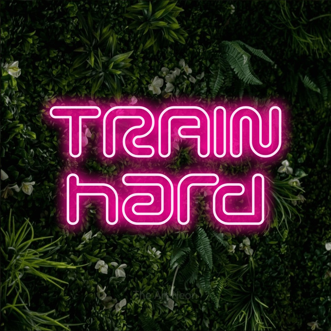 LED neon sign reading “TRAIN hard”, arranged in 2 lines.