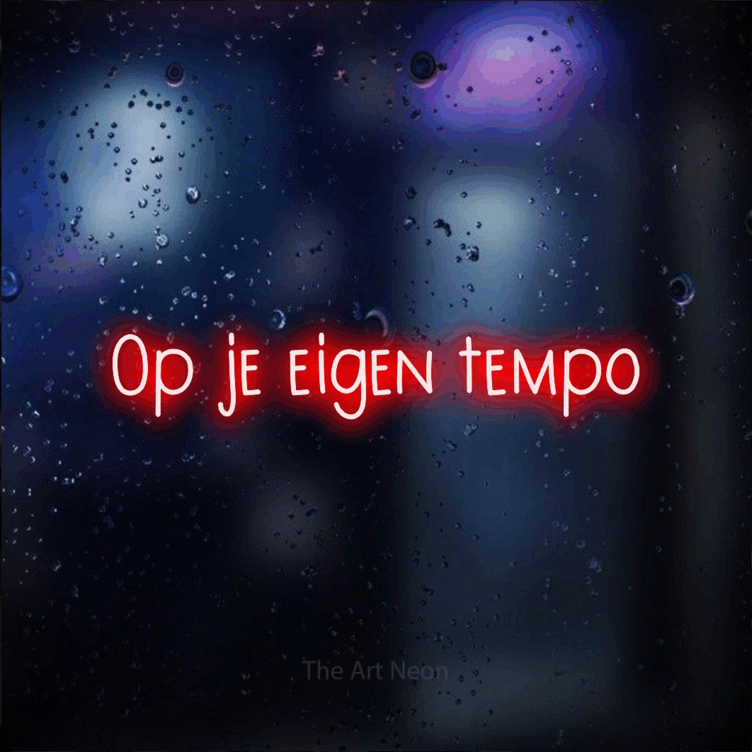LED neon sign reading “Op je eigen tempo”, arranged in a single line.
