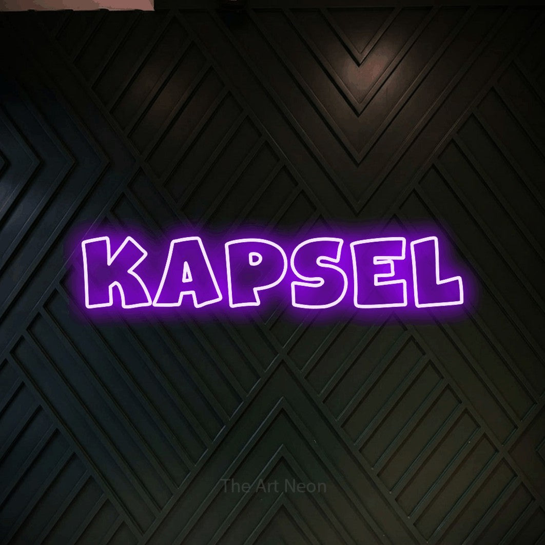 LED neon sign reading “Kapsel”, arranged in a single line.