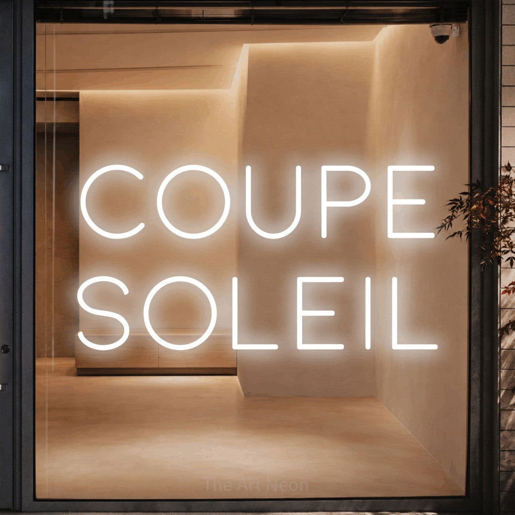 LED neon sign reading “Coupe Soleil”, arranged in 2 lines.