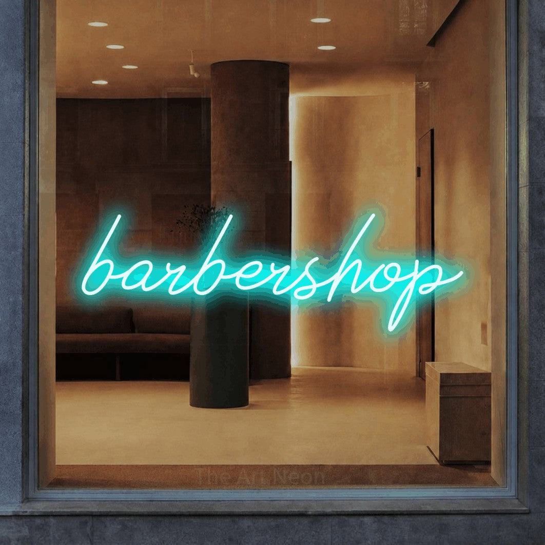 LED neon sign reading “barbershop”, arranged in a single line.