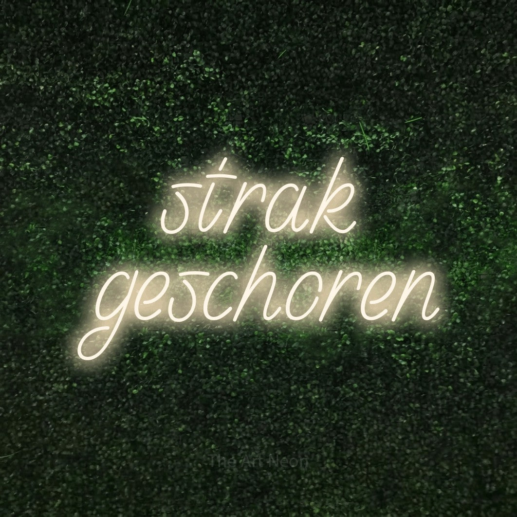 LED neon sign reading “strak geschoren”, arranged in 2 lines.