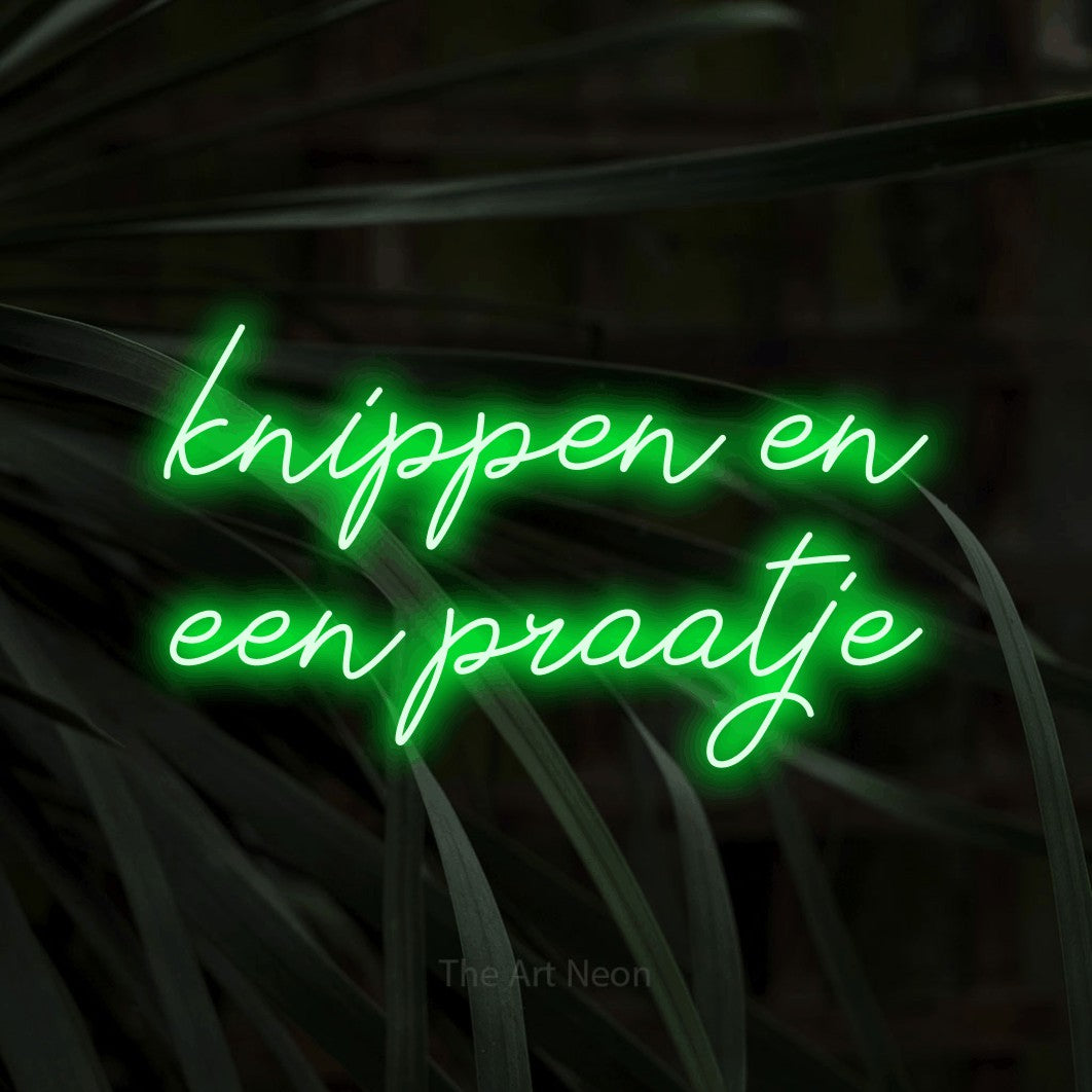 LED neon sign reading “knippen en een praatje”, arranged in 2 lines.
