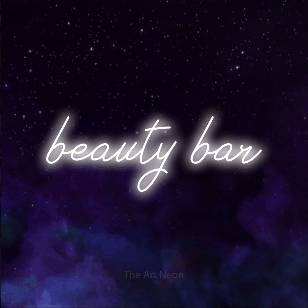 LED neon sign reading “beauty bar”, arranged in a single line.