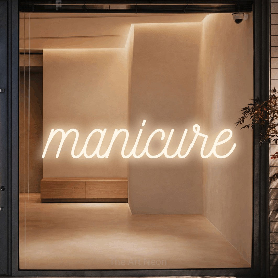 LED neon sign reading “manicure”, arranged in a single line.