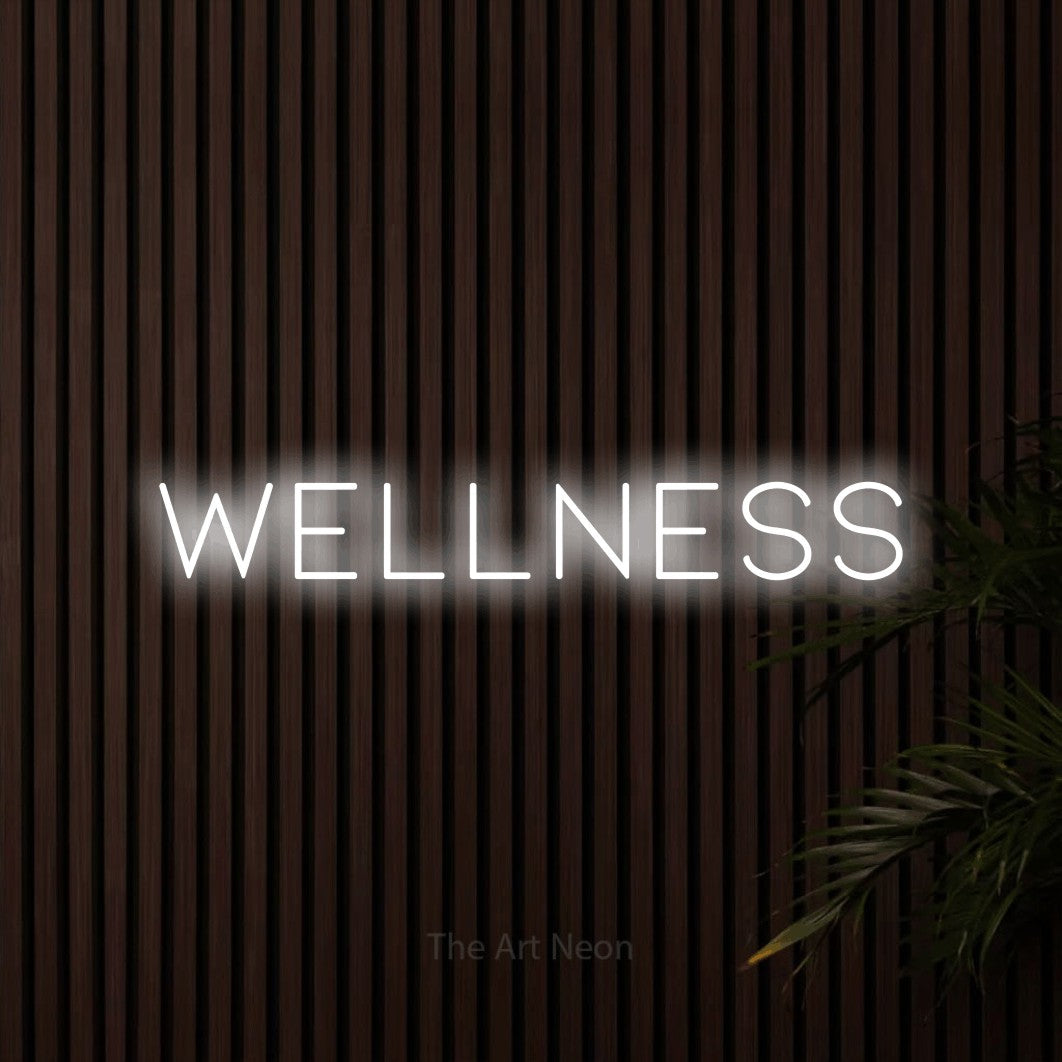 LED neon sign reading “Wellness”, arranged in a single line.