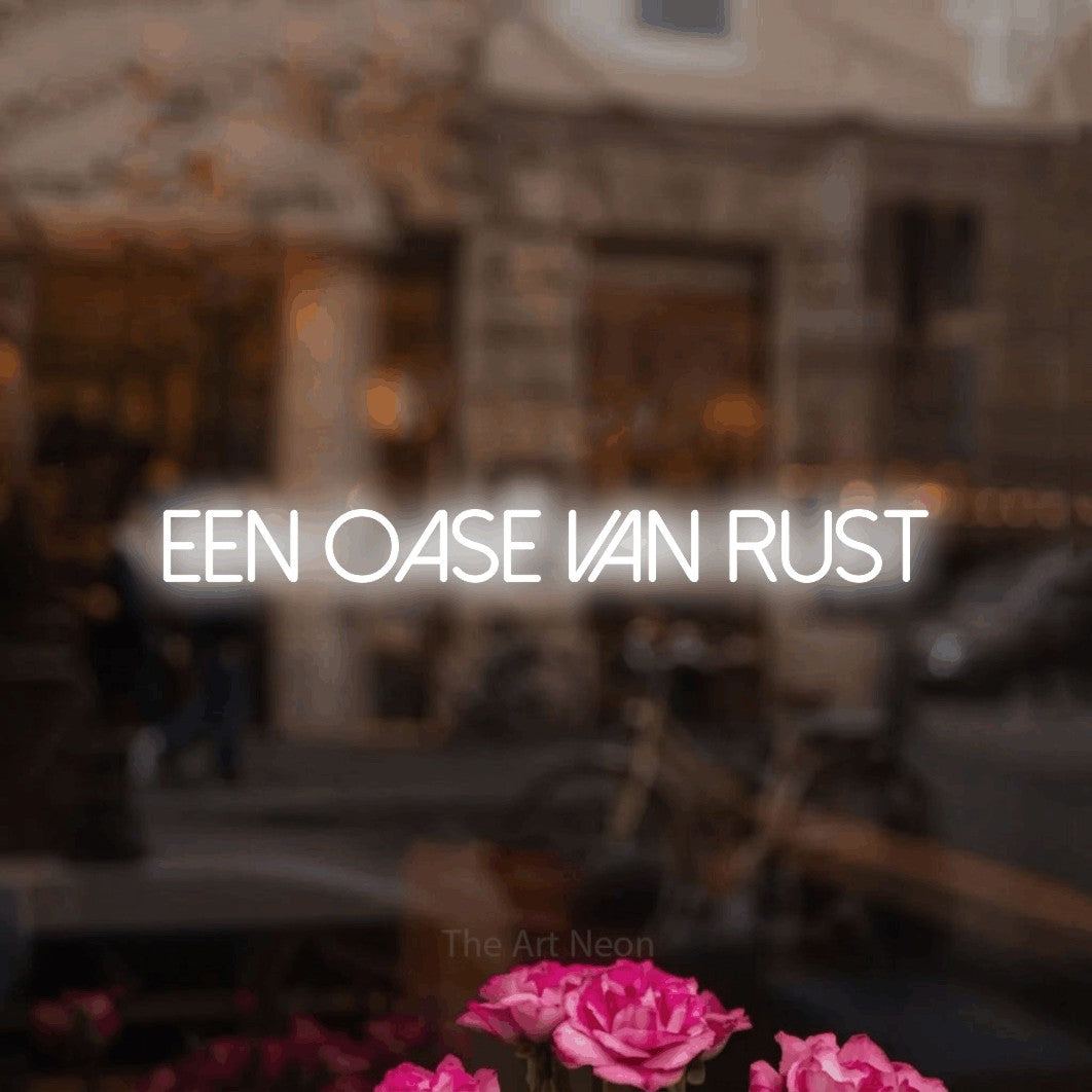 LED neon sign reading “een oase van rust”, arranged in a single line.