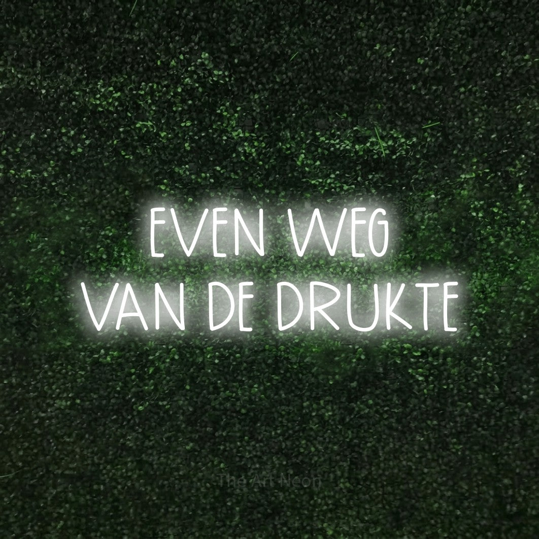 LED neon sign reading “EVEN WEG VAN DE DRUKTE”, arranged in 2 lines.