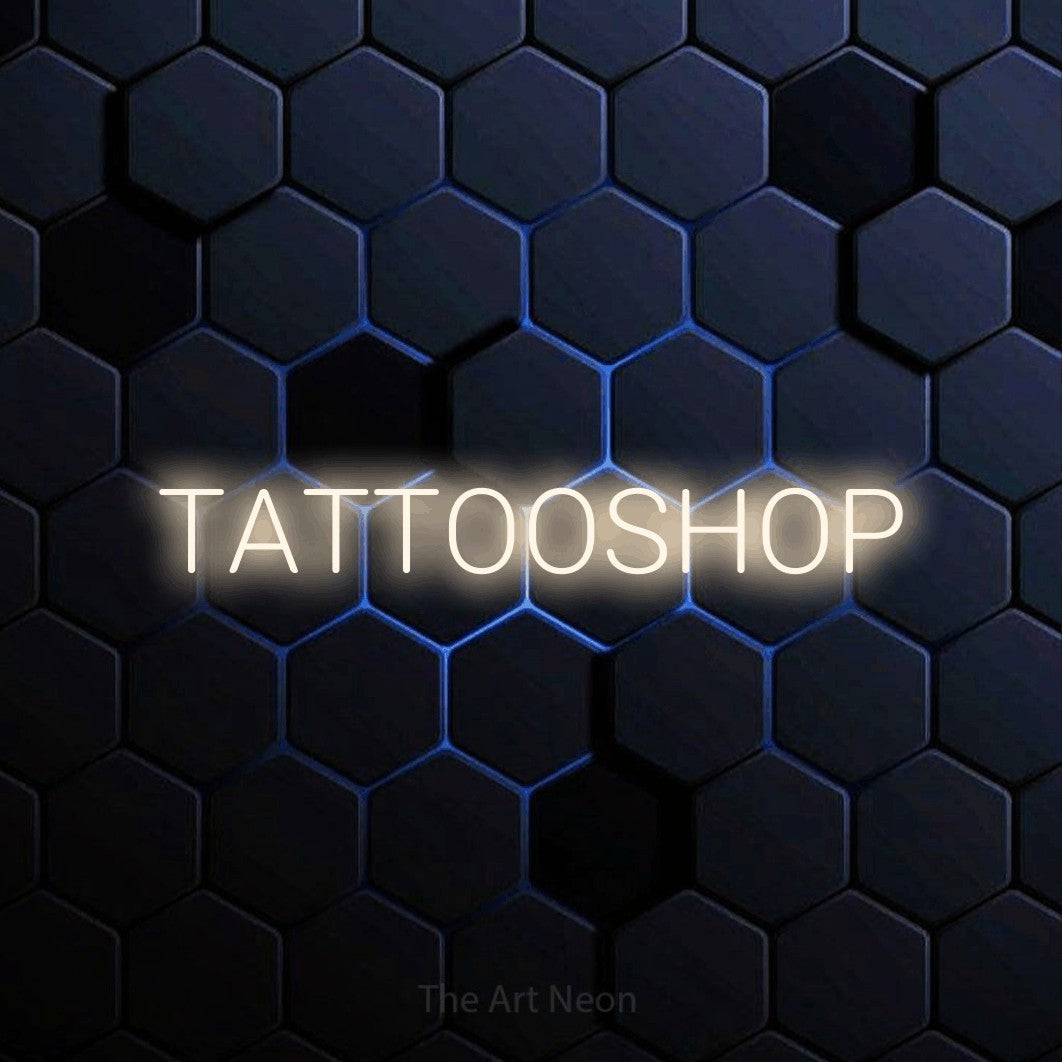 LED neon sign reading “TATTOOSHOP”, arranged in a single line.