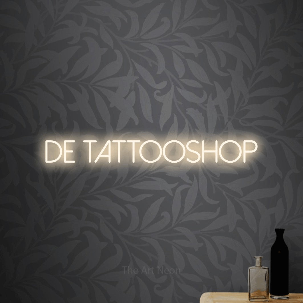LED neon sign reading “De Tattooshop”, arranged in a single line.