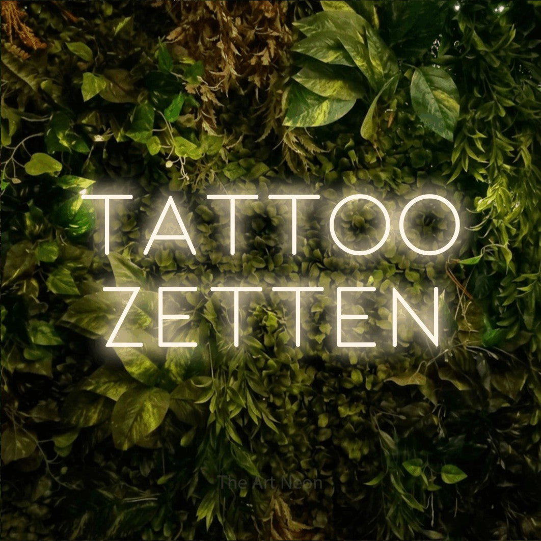 LED neon sign reading “tattoo zetten”, arranged in 2 lines.