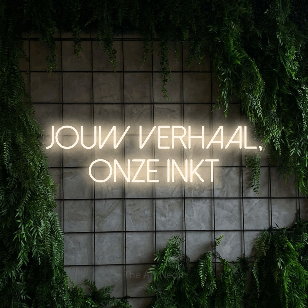 LED neon sign reading “jouw verhaal, onze inkt”, arranged in 2 lines.