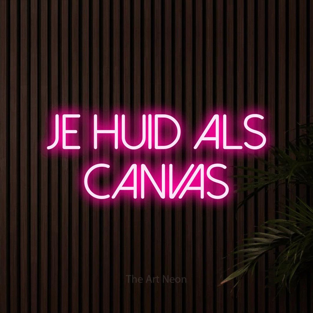 LED neon sign reading “JE huid als canvas”, arranged in 2 lines.