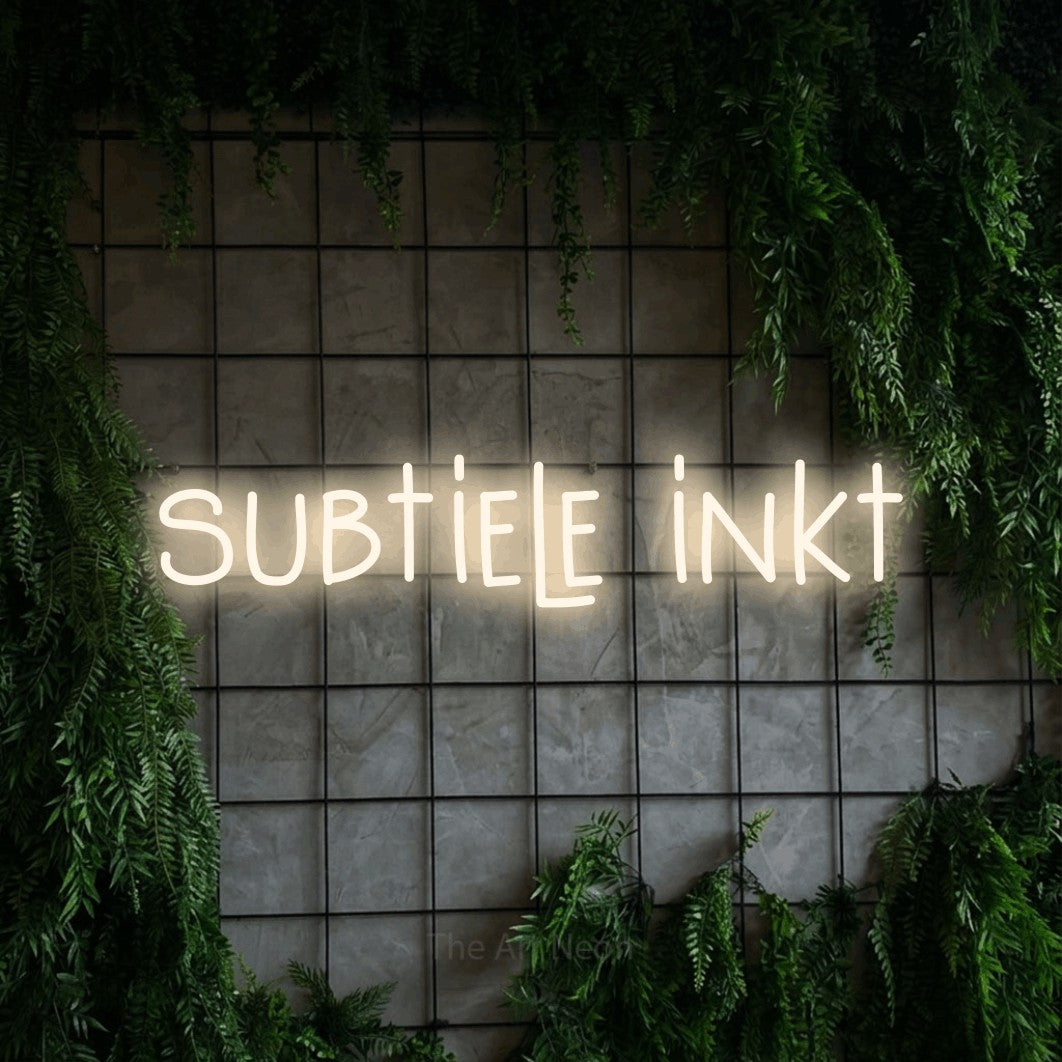 LED neon sign reading “subtiele inkt”, arranged in a single line.