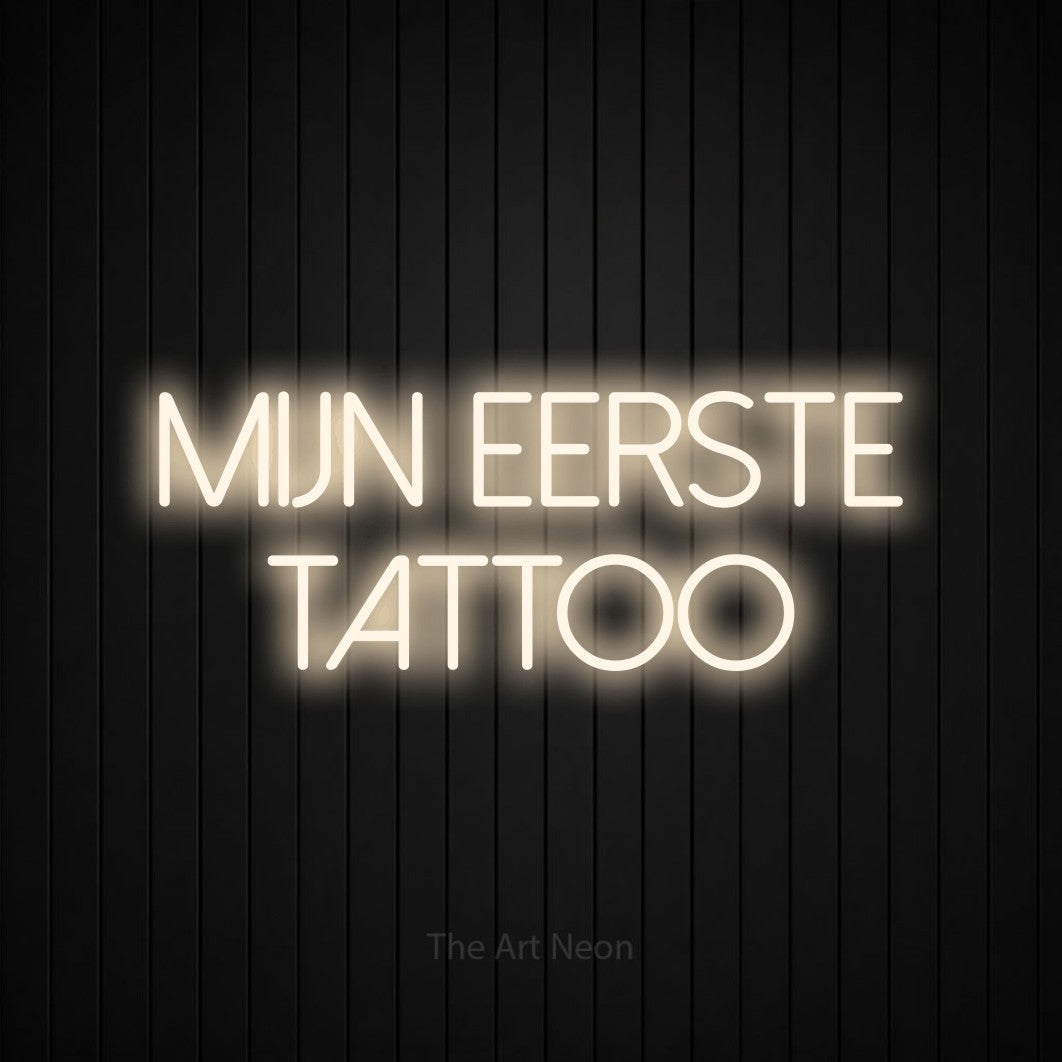 LED neon sign reading “MIJN EERSTE TATTOO”, arranged in 2 lines.