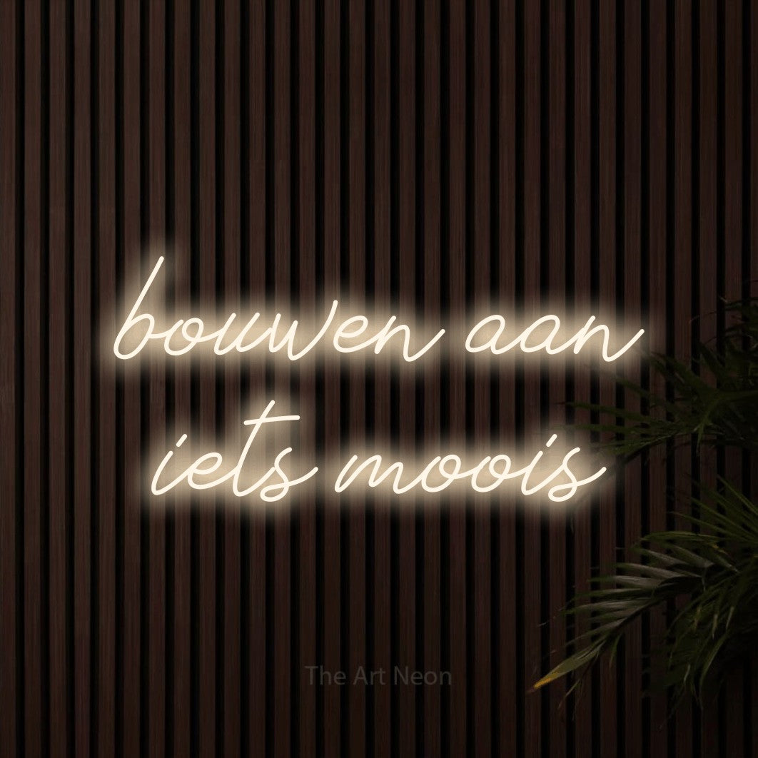 LED neon sign reading “bouwen aan iets moois”, arranged in 2 lines.