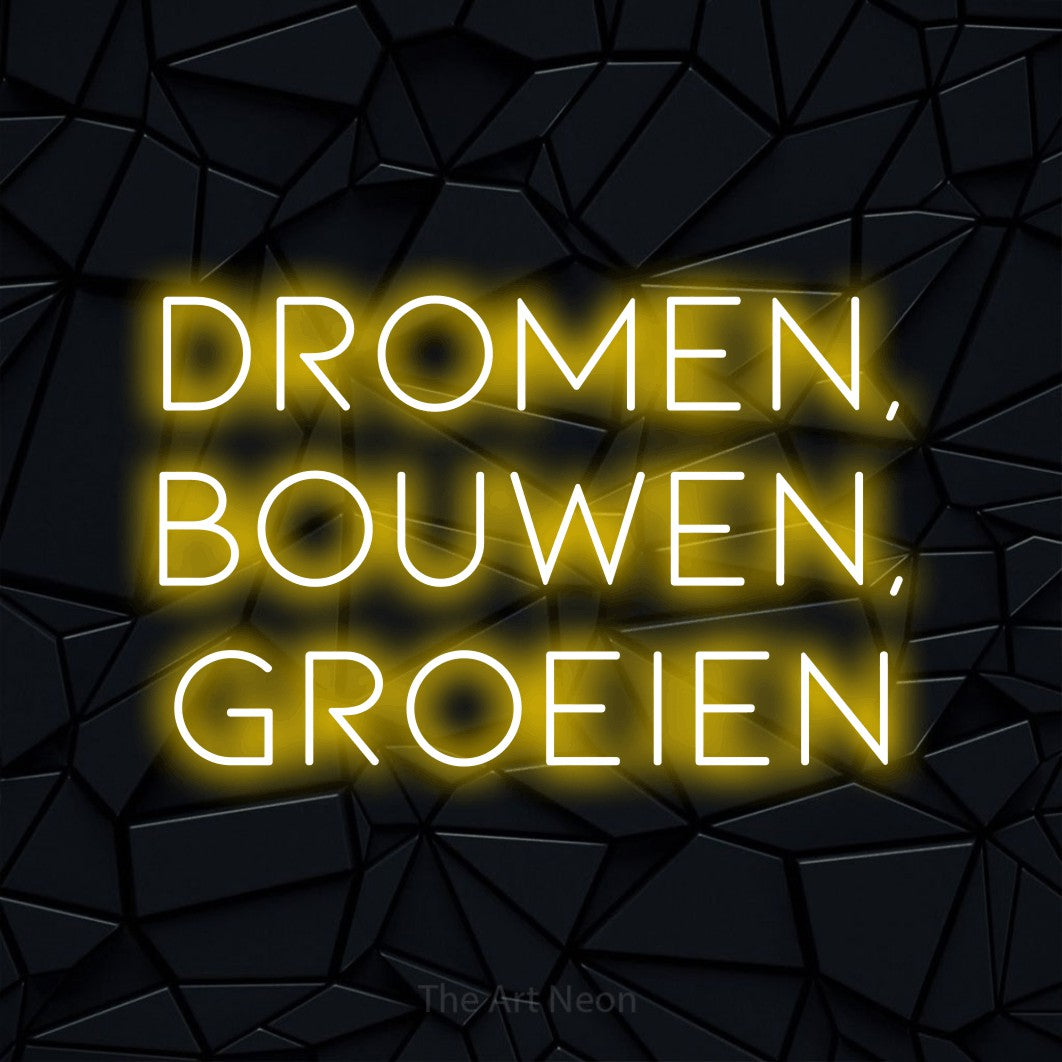 LED neon sign reading “DROMEN, BOUWEN, GROEIEN”, arranged in 3 lines.