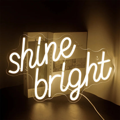 A vibrant LED neon sign displaying the words "Shine Bright" in a lively script font.