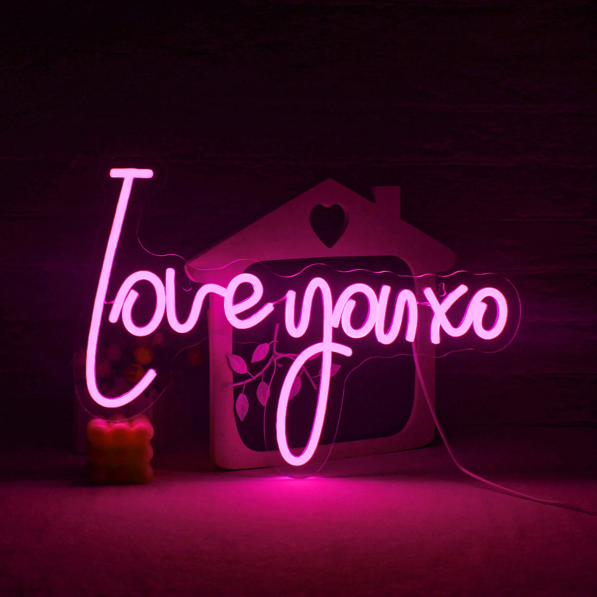 The image features a vibrant and eye-catching handmade LED neon sign displaying the phrase "Love You XO.