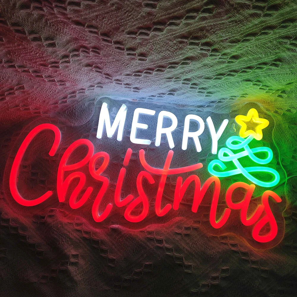 The image features a vibrant, handmade LED neon sign that spells out "Merry Christmas" in elegant, flowing script.