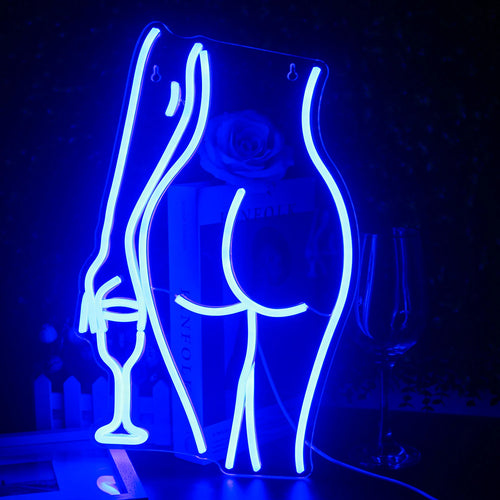 Een levendig, handgemaakt LED-neonbord in de vorm van het silhouet van een liggende vrouw.