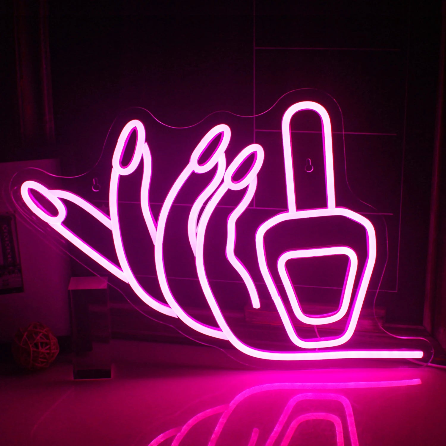 The image features a vibrant, handmade LED neon sign in the shape of a nail, glowing in bright pink.