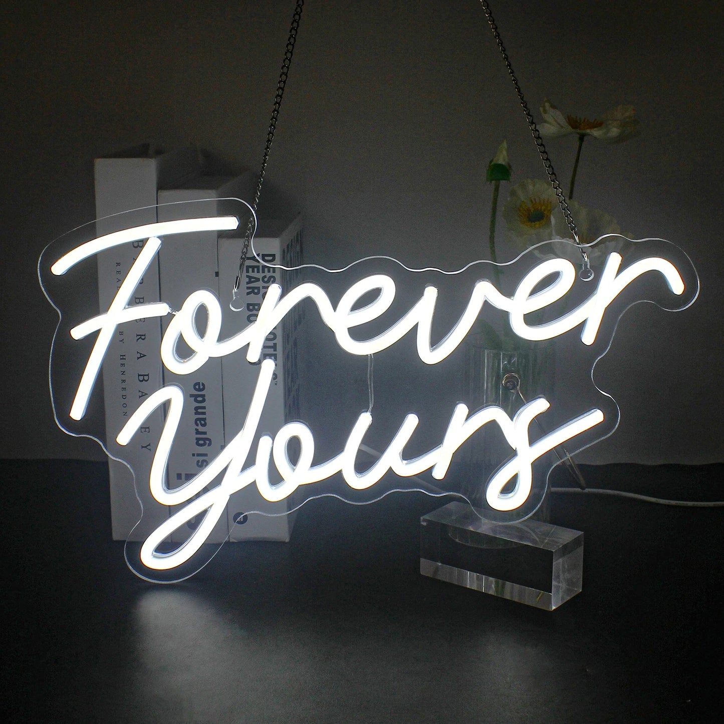 A vibrant LED neon sign displaying the phrase "Forever Yours" in elegant cursive lettering.