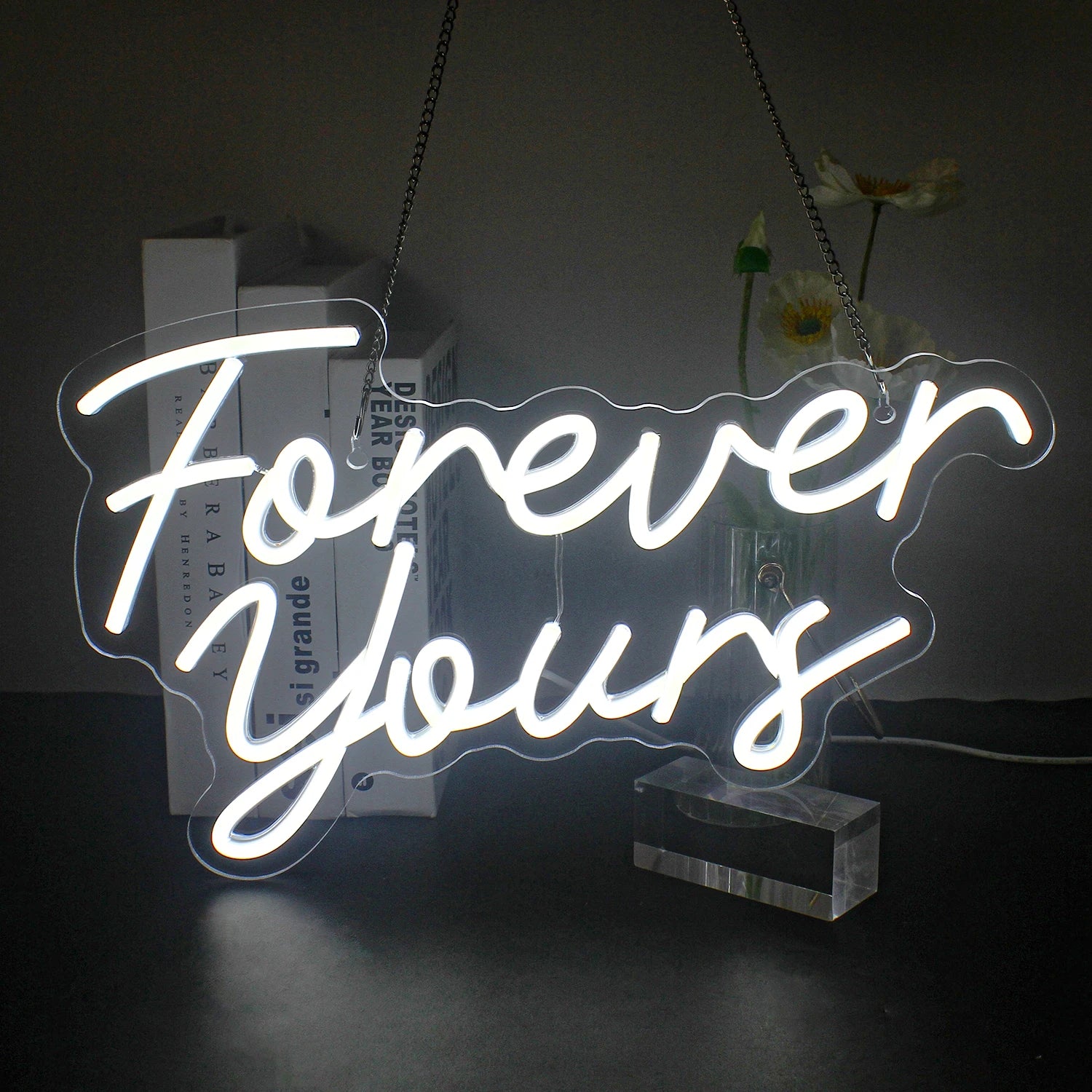A vibrant LED neon sign displaying the phrase "Forever Yours" in elegant cursive lettering.