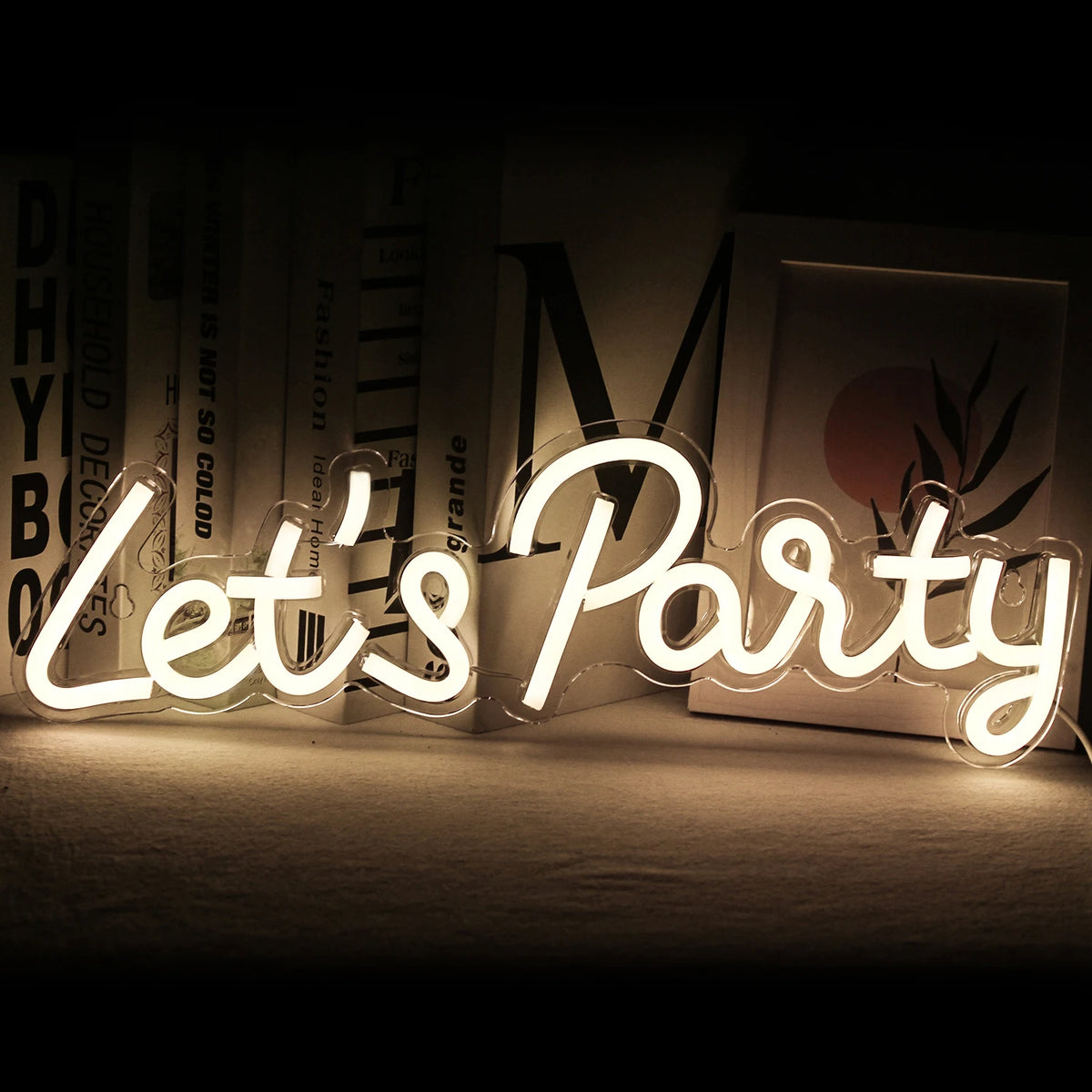 The image features a vibrant, handmade LED neon sign that reads "Let's Party" in playful, cursive script.
