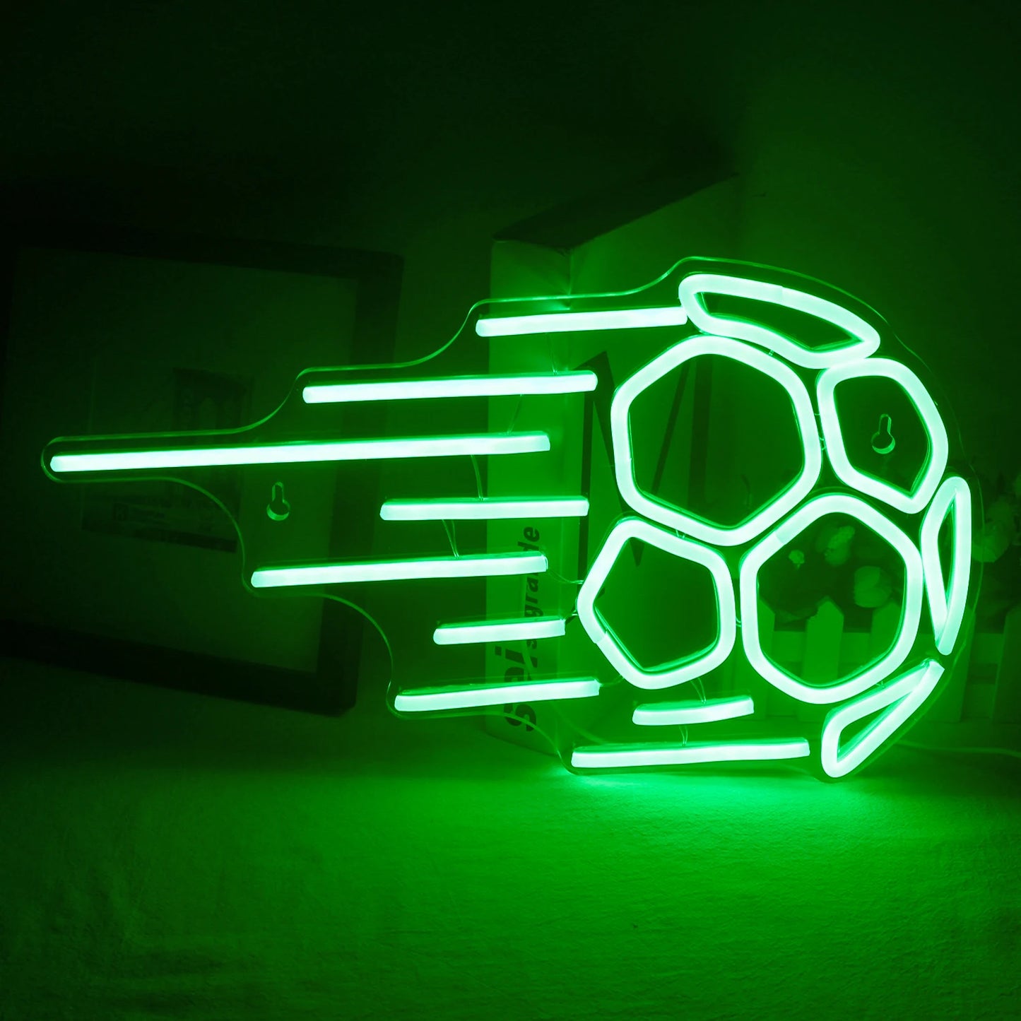 The image showcases a vibrant LED neon sign in the shape of a soccer ball.