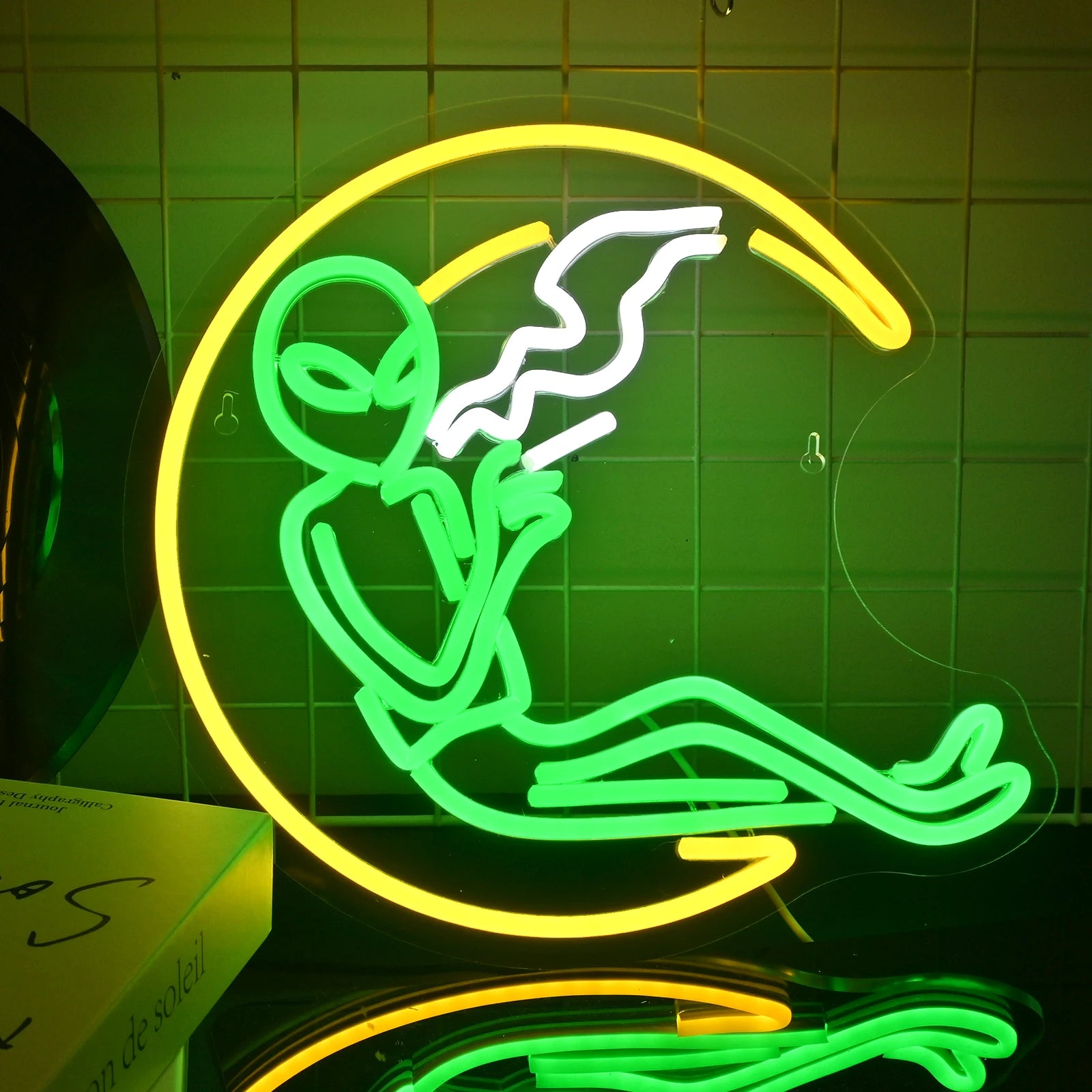 A vibrant LED neon sign depicting a whimsical alien character.