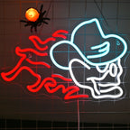 The image features a vibrant LED neon sign in the shape of a skull wearing a cowboy hat.