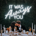 The image features a handmade LED neon sign displaying the phrase "It Was Always You" in elegant, flowing script.