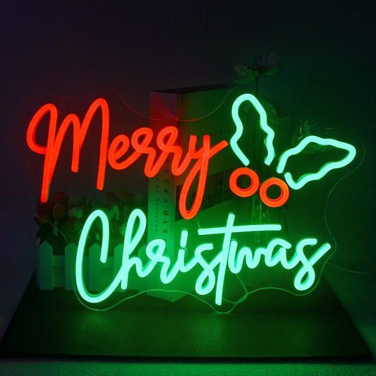 A vibrant "Merry Christmas" LED neon sign is displayed against a dark background.