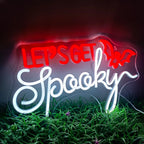 The image features a vibrant LED neon sign displaying the words "Let's Get Spooky" in a bold, quirky font.