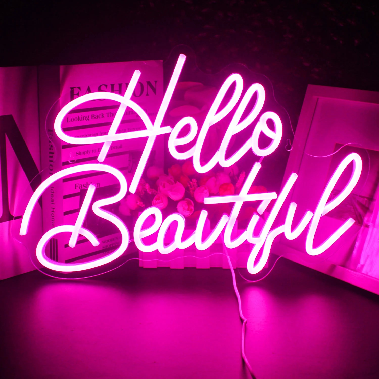 A vibrant LED neon sign displaying the words "Hello Beautiful" in a graceful, flowing script.