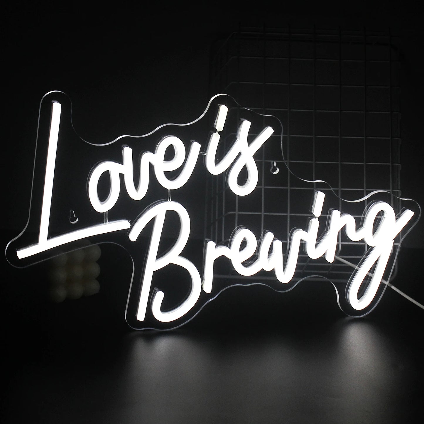 A vibrant LED neon sign displaying the phrase "Love is Breaking," featuring bold, modern typography.